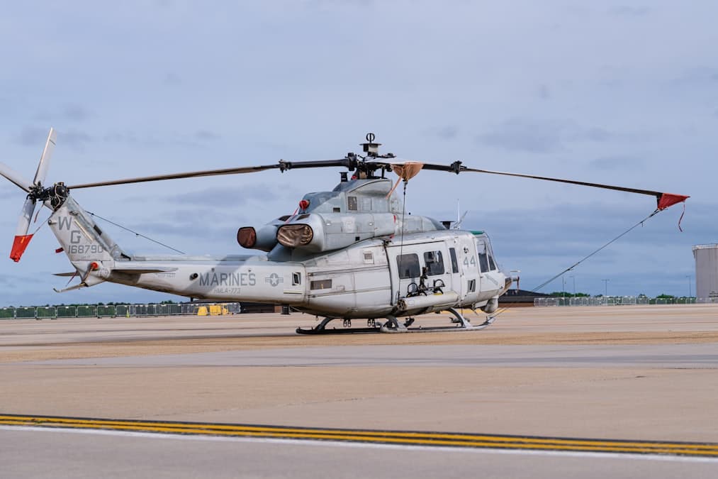A helicopter sits on the runway.